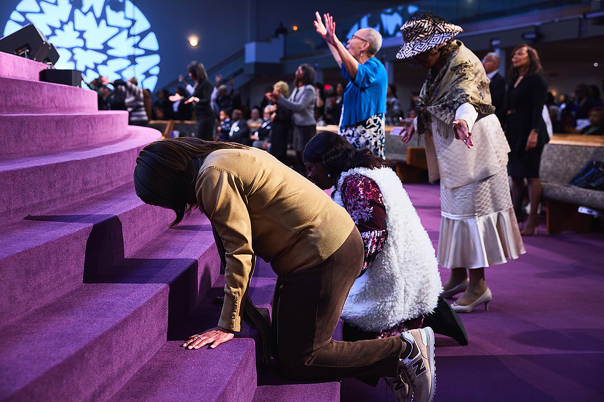  Congregants kneeling and praying at the altar during a powerful worship moment in church.